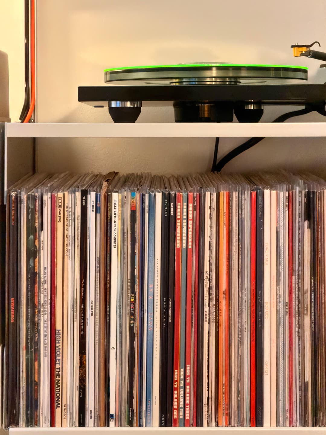 Rega P6 turntable with vinyl records on shelf